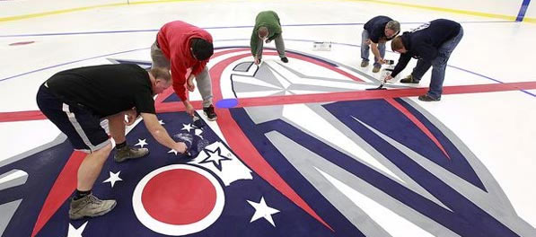 Picture Of People Installing Graphics On An Ice Skating Rink - The Chiller